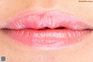 a close up of a woman's lips with a pink lipstick