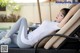 A woman laying on a lounge chair with her legs crossed.