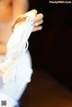 A woman in a wedding dress holding a white napkin.