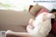 A woman laying on a couch with her feet up.